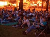 Things to in Orlando: image of people watching a free movie outdoors during Popcorn Flicks at the Park