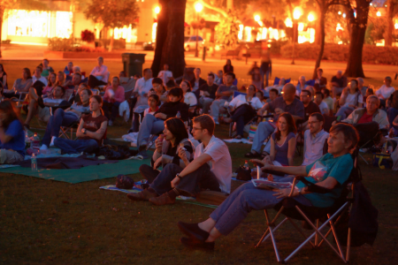 Things to in Orlando: image of people watching a free movie outdoors during Popcorn Flicks at the Park