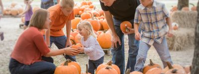 Orlando Pumpkin Patches: image of family picking pumpkins at Santa's Farm in Eustis, FL