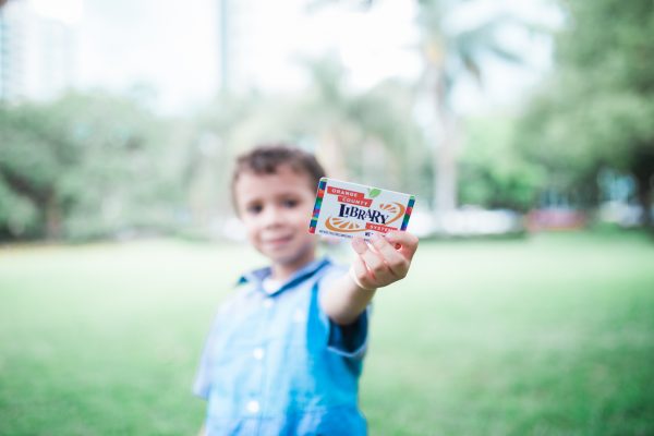 Orlando library free resources: image of a child holding his library card