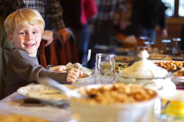 Thanksgiving Orlando: image of child eating a Thanksgiving dinner