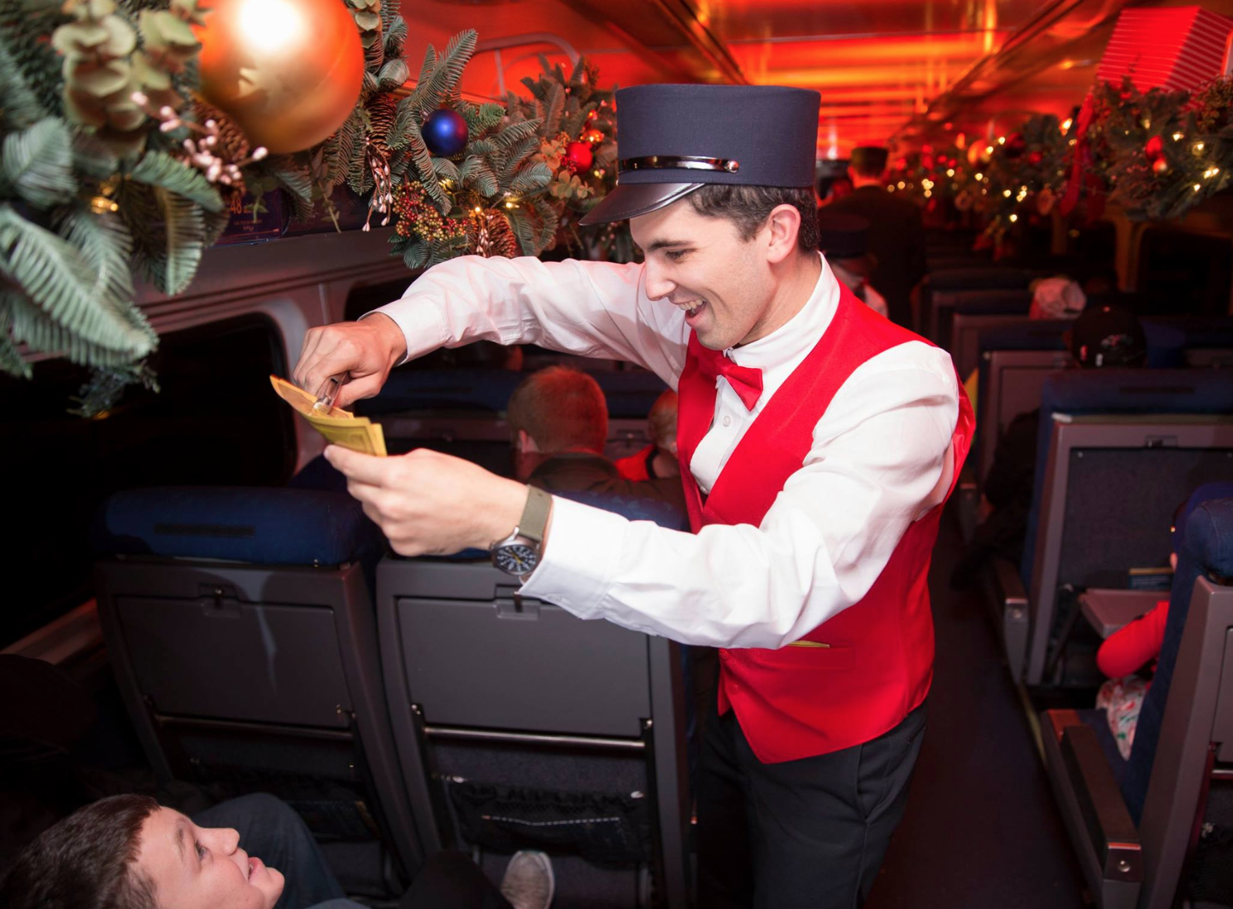The Polar Express Train Ride Orlando: image of conductor marking golden ticket on train
