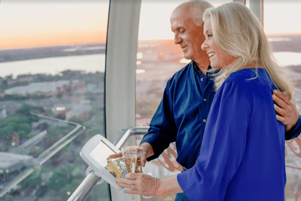 Romantic dates Orlando: image of couple riding The Wheel above Orlando's skyline at ICON Park