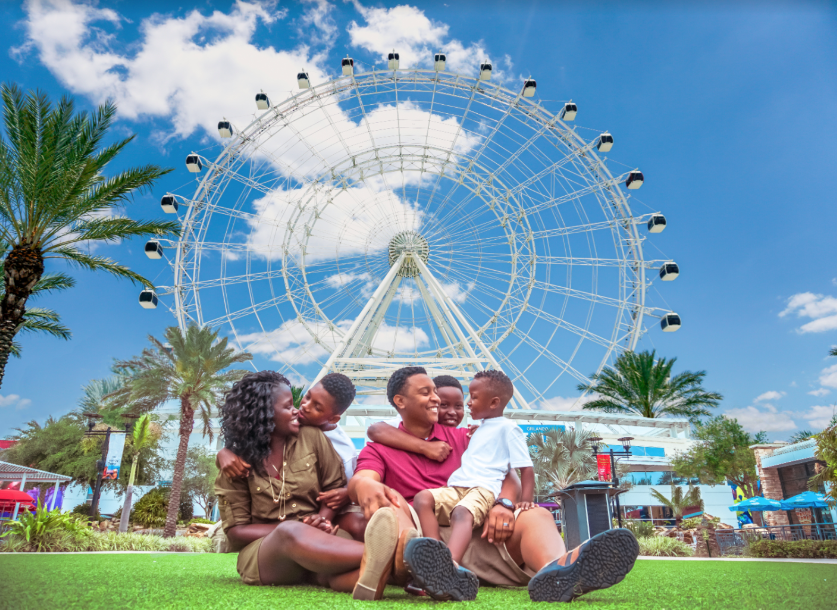 The Wheel ICON Park discounts: image of a family of four in front of The Wheel ride at ICON Park in Orlando