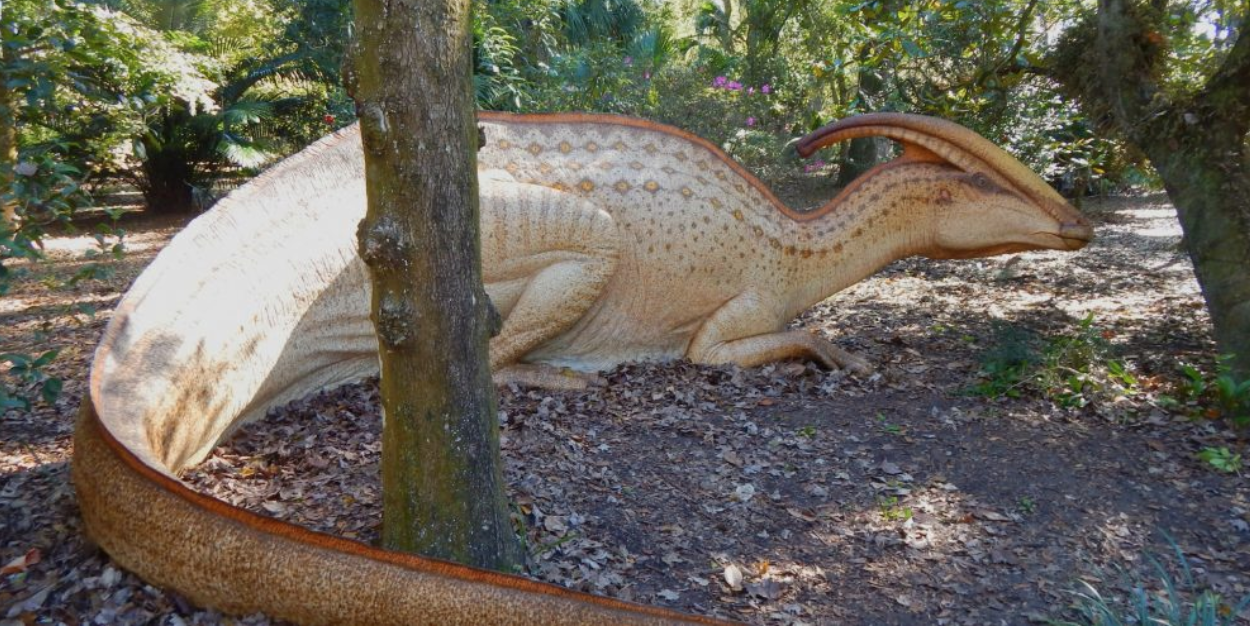 Things to do Orlando: image of life-size dinosaur in Leu Gardens. Dinosaur Invasion exhibit comes to Harry P. Leu Gardens in Orlando.