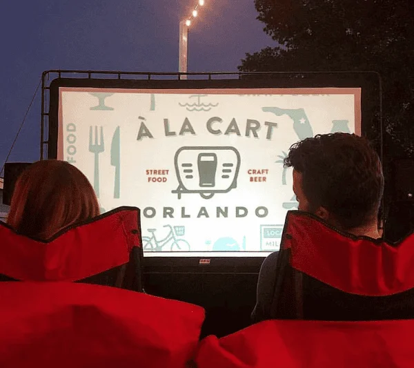 Outdoor movies Orlando: image of a couple watching a free outdoor movie at A La Cart Orlando