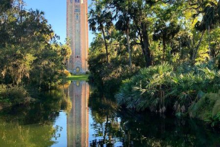 Orlando outdoor date ideas: image of the Bok Tower surrounding by trees and a beautiful landscape at Bok Tower Gardens in Lake Wales, Florida