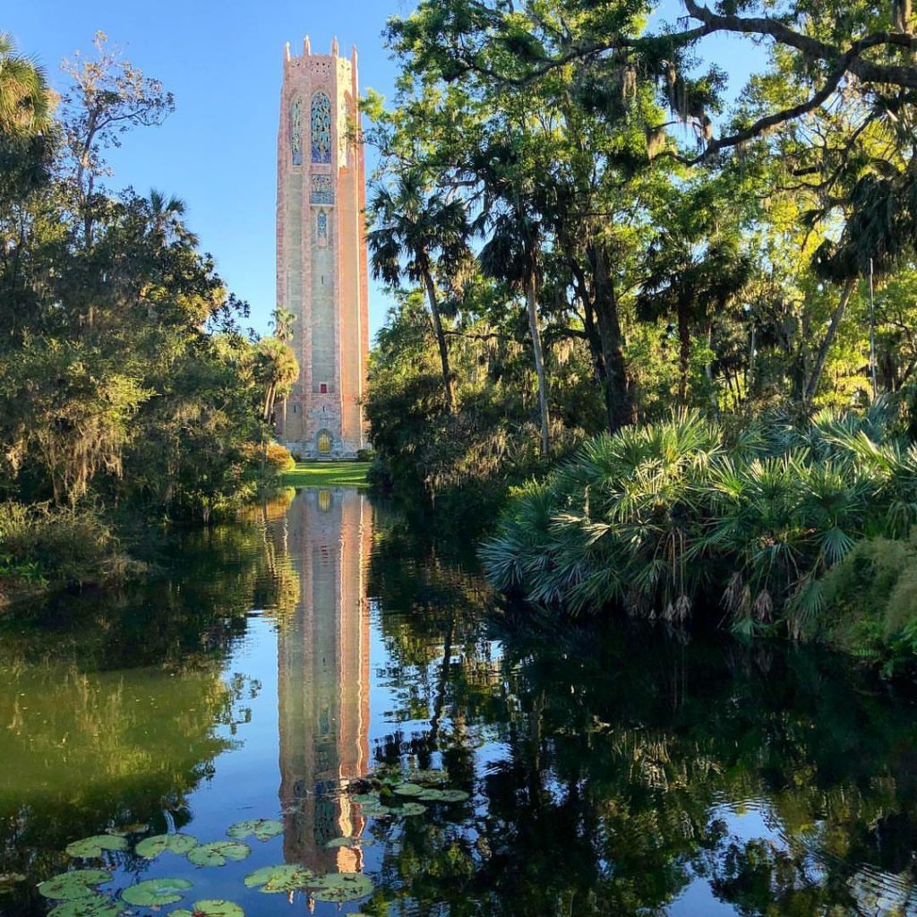Orlando outdoor date ideas: image of the Bok Tower surrounding by trees and a beautiful landscape at Bok Tower Gardens in Lake Wales, Florida