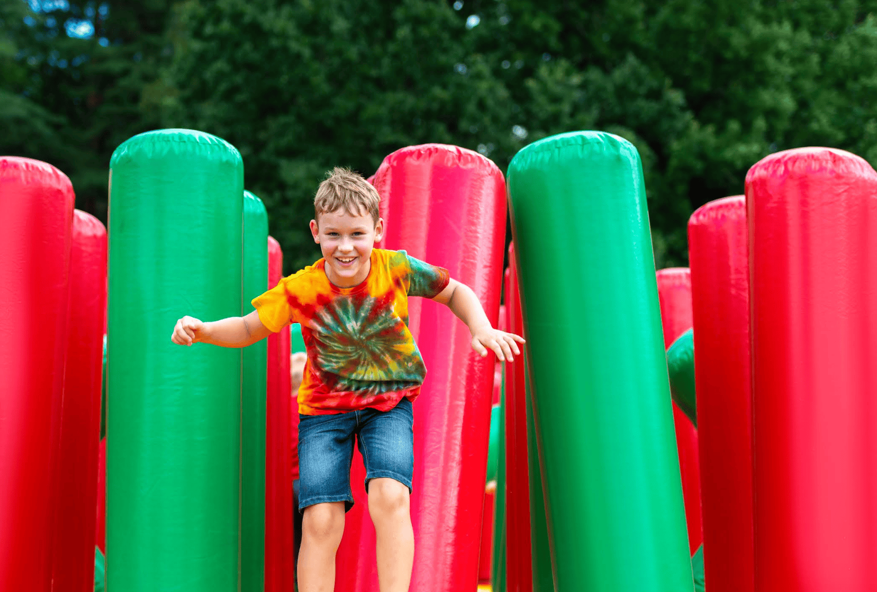 Free and cheap things to do in Orlando this weekend: image of a boy in a bounce house for Celebrate! Lake Mary, a free annual event