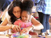 Things to do Orlando: image of a mom and daughter make a free craft at the Mennello Museum of Art in downtown Orlando